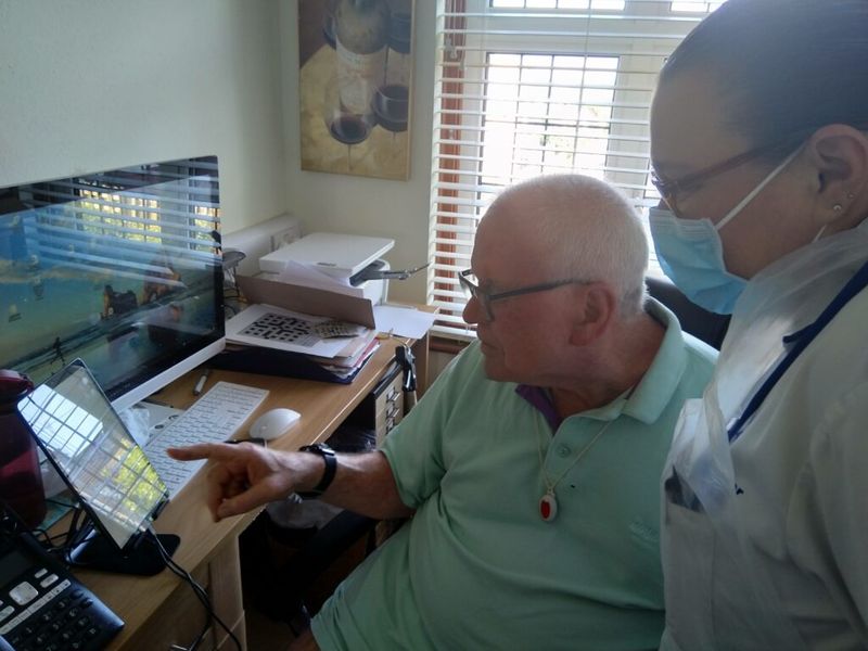 Image of an elderly man being supported by his careworker using his KARA device