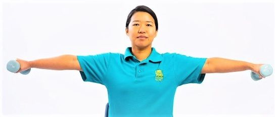 Weight Loss Adviser Teela Limbu sitting down lifting weights