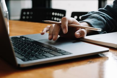 A person completing a task on a laptop.