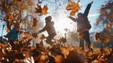 Children playing in autumn leaves