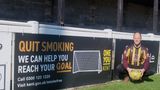 Dan Watkins with a pitchside smokefree banner  