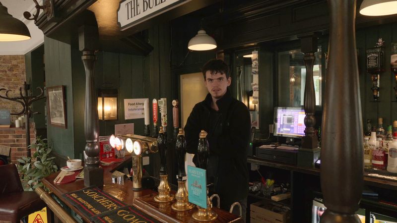 Picture shows Archie standing behind the bar at the pub he worked at