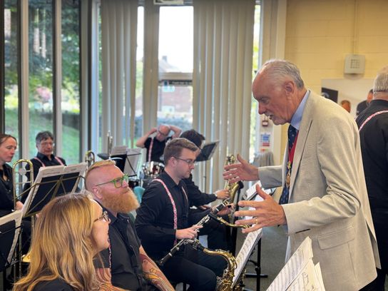 Chairman of KCC Bryan Sweetland talks to some of the musicians playing big band music at the Victory in Europe anniversary event in Aylesford