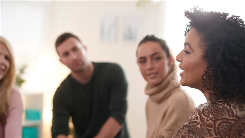 Woman speaking at a support group meeting