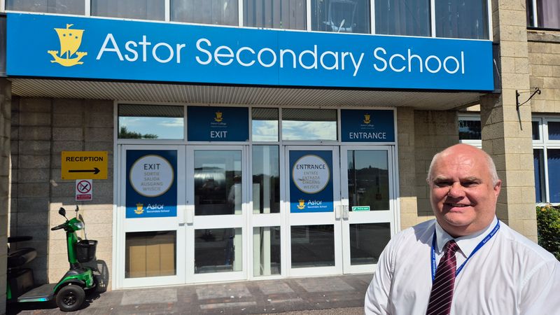 Head teacher Lee Kane standing outside the entrance to Astor Secondary School 