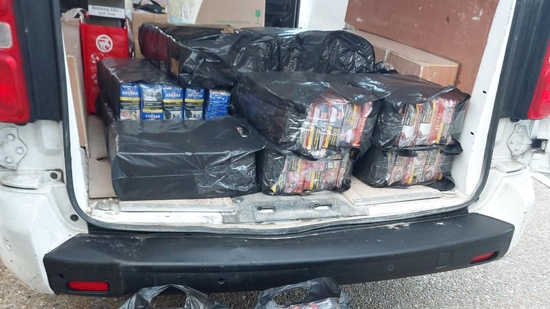 Black bags full of seized packs of illegal tobacco on floor