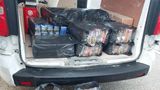 Black bags full of seized packs of illegal tobacco on floor