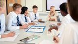 A teacher speaking to young people in a classroom