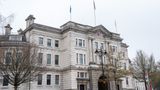 A landscape image of the front of Sessions House with the flag poles on top.