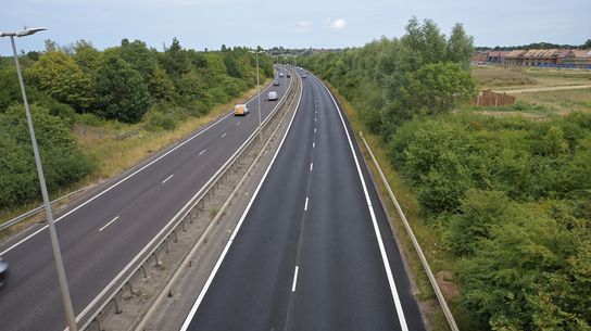Overview of the A299 Thanet Way after resurfacing works, showing the improved carriageway stretching through a green corridor.