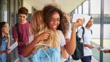 Image of young people hugging after getting exam results