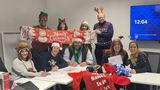 Members of KCC's Corporate Parenting team wearing Christmas hats and celebrating reaching the appeal target