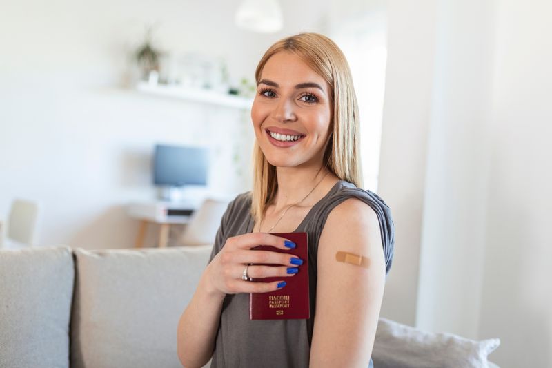 Young woman with plaster on arm where she's been vaccinated