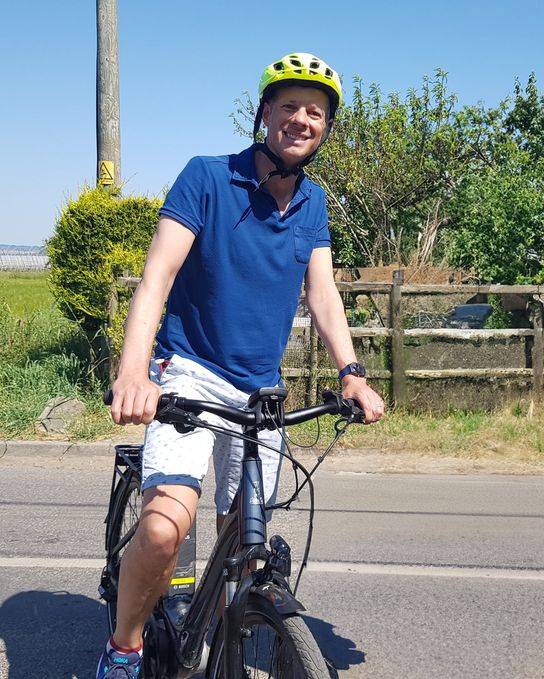 Dan Watkins with his bike on a country road