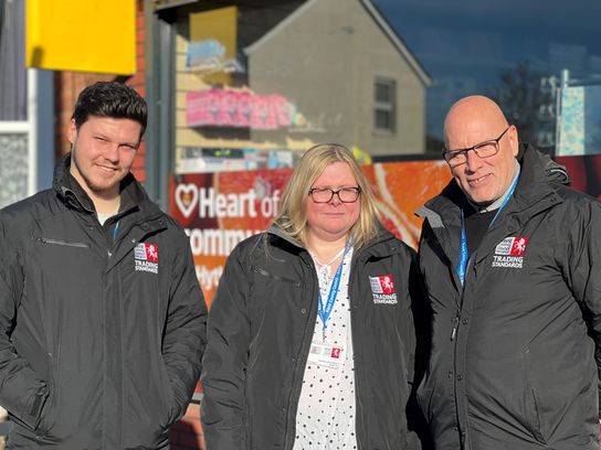 The Vape Compliance Team - a team of three standing outside a newsagents shop in Ashford