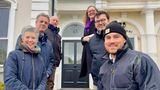 A group of six officers and members from Kent County Council and Folkestone and Hythe District Council stand on the front steps of 45 Augusta Gardens in Folkestone with the developer after its refurbishment