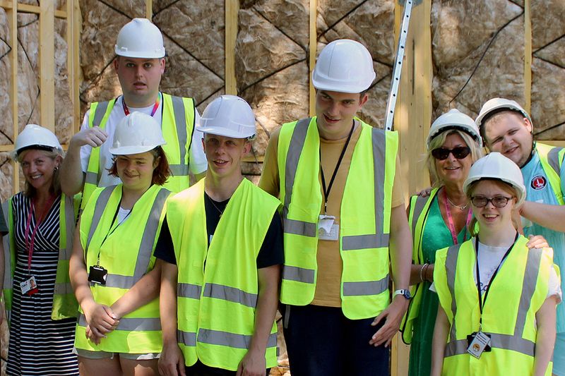 A group of learners wearing hard hats and high-vis jackets during the construction of the new college building called The Point.