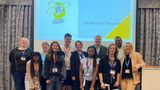 A group of young people and adults in front of a sign saying Big Mental Health Conversation