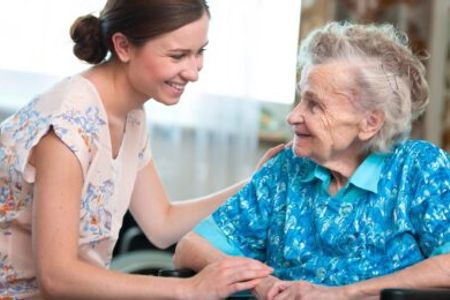 Care worker helping elderly lady