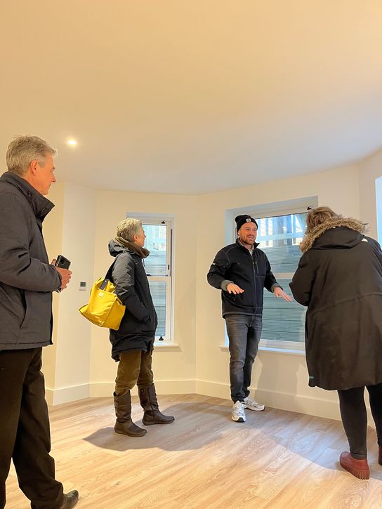 Four people looking around a newly-refurbished flat in Folkestone