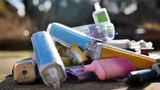A pile of colourful used disposable vapes on the ground