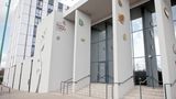 An exterior landscape photo of the glass doors at the Kent History and library centre. entrance