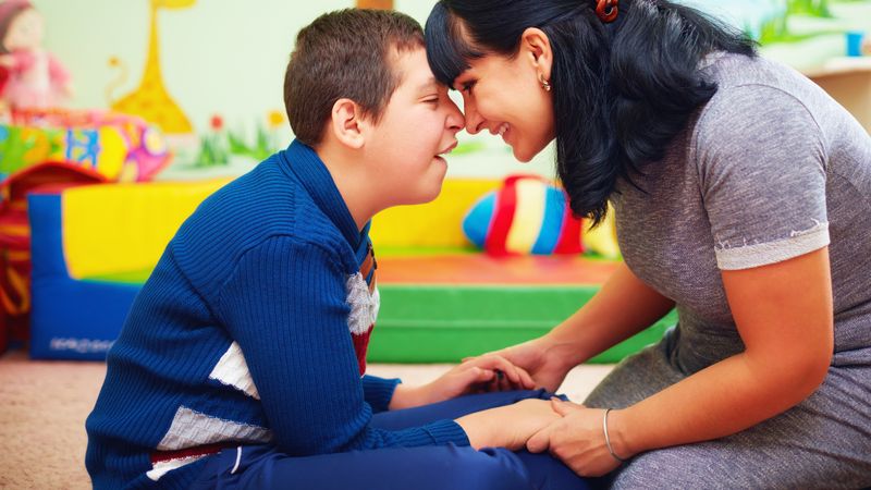 Pupil and teacher holding hands.