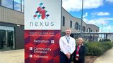 Beverley Fordham, KCC Cabinet Member for Education and Skills, standing with head teacher Scott Jarred next to a sign outside Nexus School 