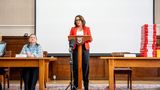 Limden Kemkaran stands at a podium addressing the media