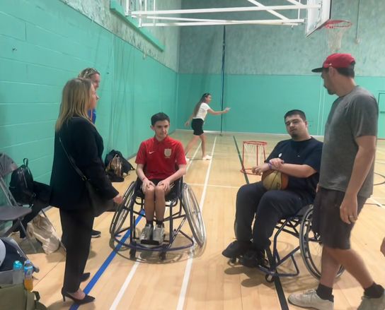 KCC Member for Education Beverley Fordham speaking with some young people playing wheelchair basketball