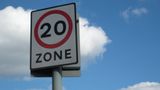 A 20mph zone sign shown infront of blue sky.