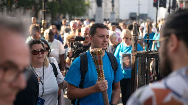 A man carrying the Baton of Hope 