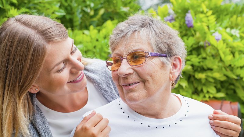 Carer supporting and older lady