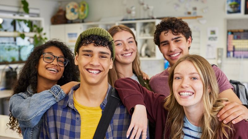 A group of teenagers smiling at the camera.