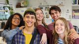 A group of teenagers smiling at the camera.