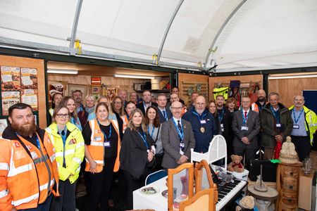 Group of staff, partners and supporters gathered inside the Reuse Shop at New Romney Household Waste Recycling Centre following its opening.
