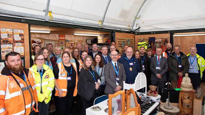 Group of staff, partners and supporters gathered inside the Reuse Shop at New Romney Household Waste Recycling Centre following its opening.