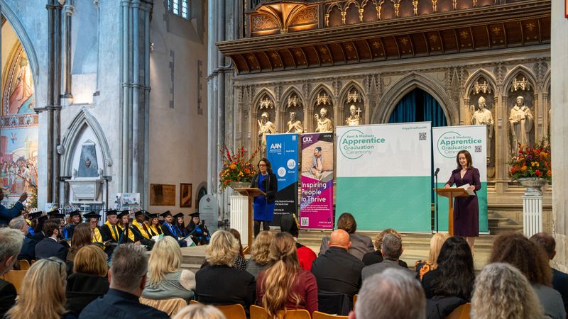 Linden Kemkaran on a stage at the Kent and Medway Apprentice Graduation Ceremony