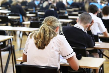 Girl in school uniform taking an exam