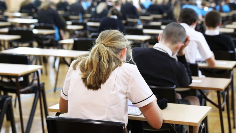 Girl in school uniform taking an exam