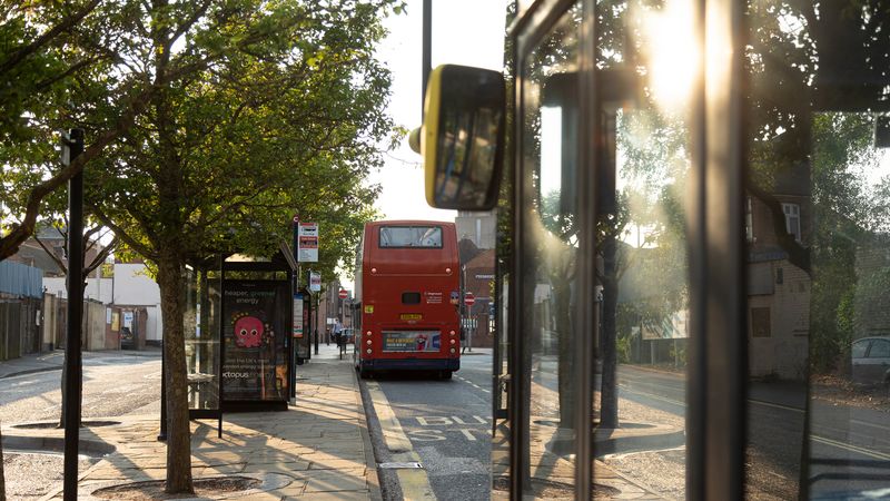 Image of the back of bus parked at a bus stop