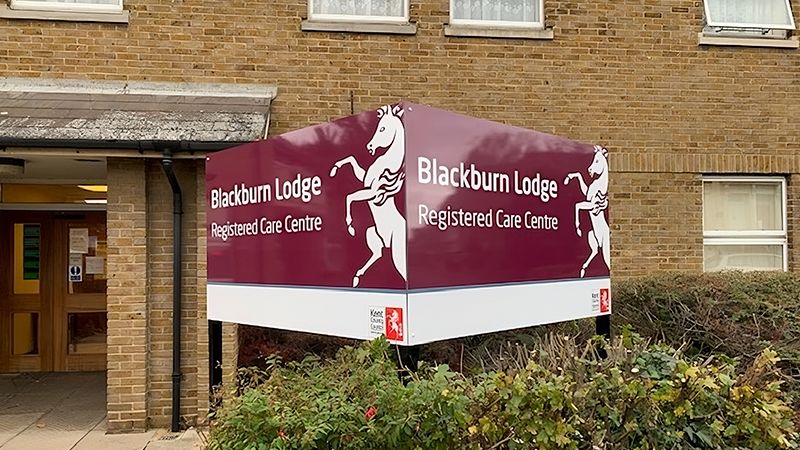 Front of Blackburn Lodge building with sign