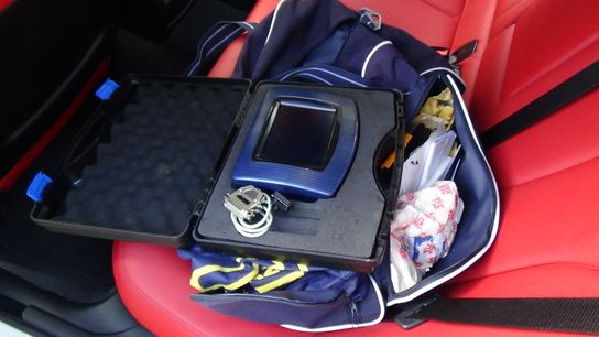 Electronic equipment on the front seat of a van used to alter mileage