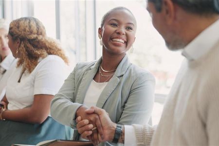 Woman shaking hands at a networking event