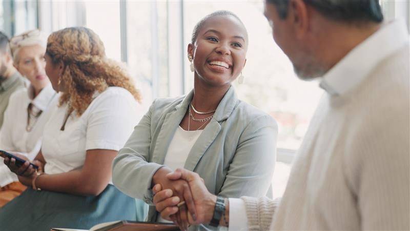 Woman shaking hands at a networking event
