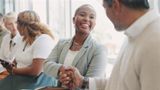 Woman shaking hands at a networking event