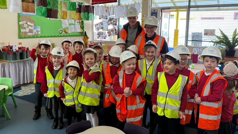 Primary school pupils from Teynham Parochial Church of England Primary School visiting their new school building wearing hi-vis jackets and hard hats