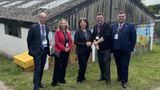 Staff from Homewood School and members of Kent County Council stand outside one of the buildings on the school's farm