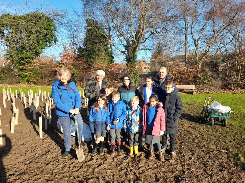 KCC Vice Chair, Gary Cooke, with pupils and staff from West Malling CE Primary School and local Member Trudy Dean helping to plant trees