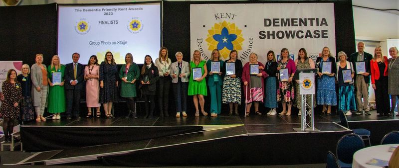 Finalists in this year's Dementia Friendly Kent Awards line up on the stage at the Kent Event Centre with KCC Leader Roger Gough